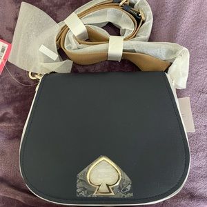 Authentic navy blue Kate Spade handbag. New with tags. Suzy large saddle.